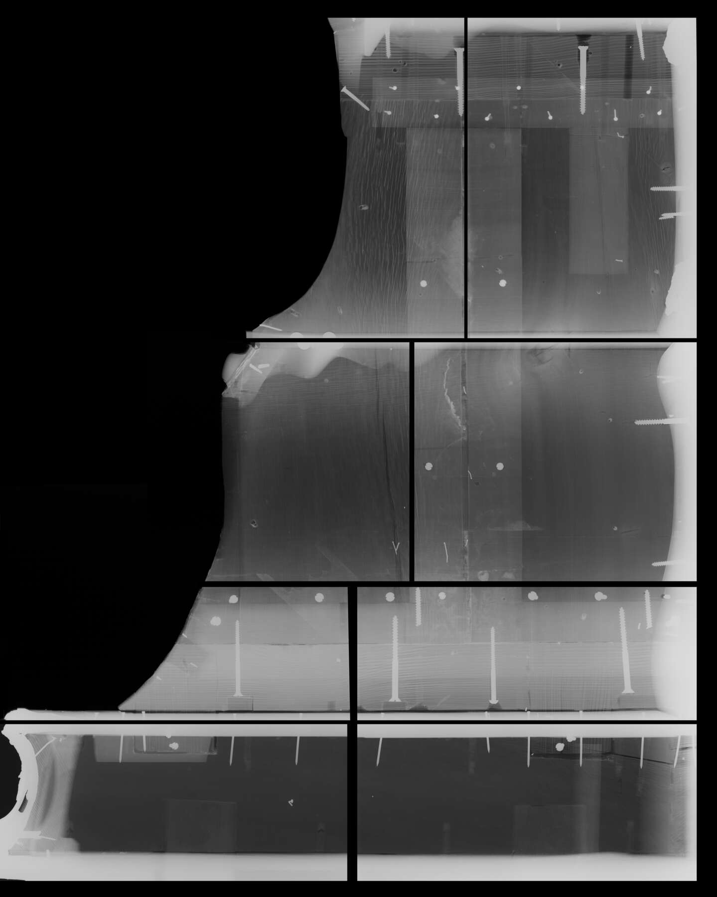 black-and-white x-ray of the top portion of the corner cabinet, revealing numerous screws throughout the interior