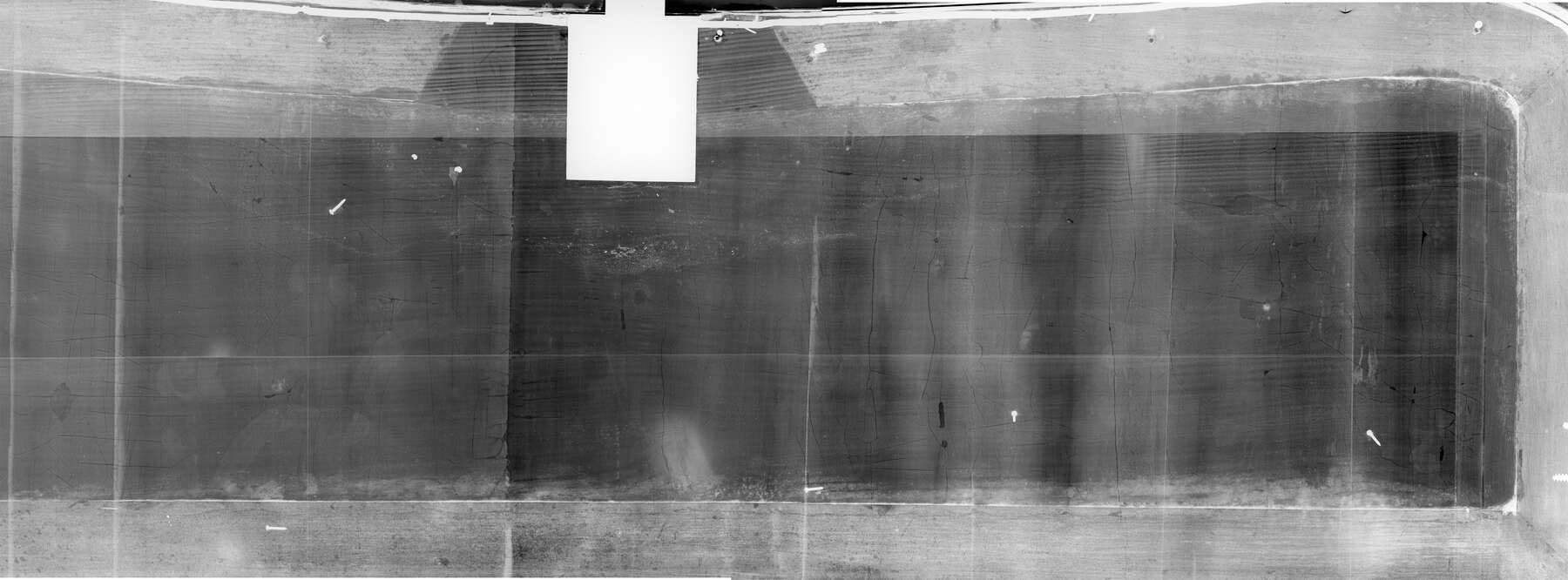 black-and-white composite x-ray of the pull-down writing surface, revealing the joinery holding multiple horizontal pieces of wood together