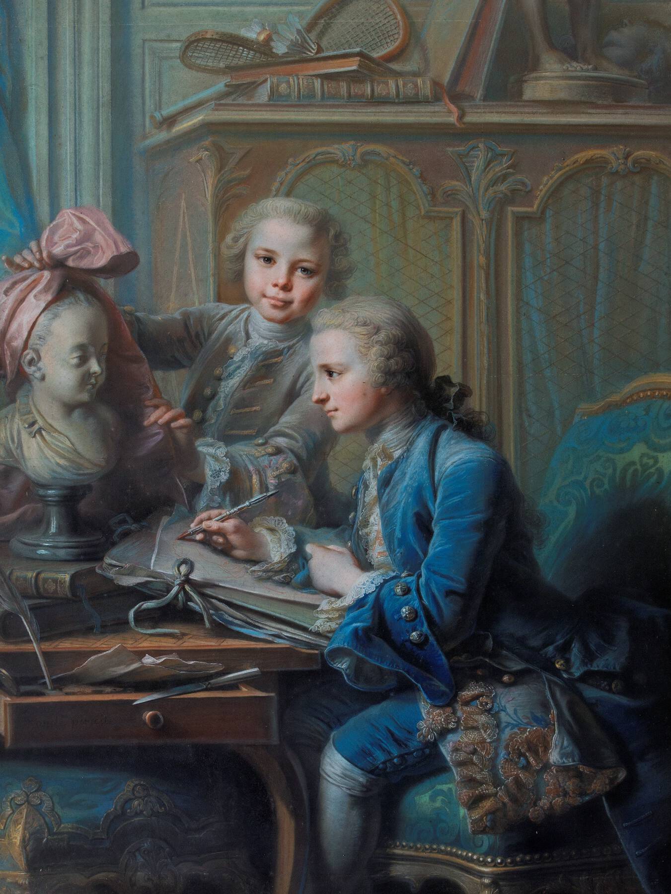 two young boys dressed in elaborate 18th-century costumes in varying shades of blue, positioned in front of a cabinet with wire mesh; one sits at a desk with an open drawer and writes, while the other stands behind the desk and holds a piece of pink satin against a white bust of a woman