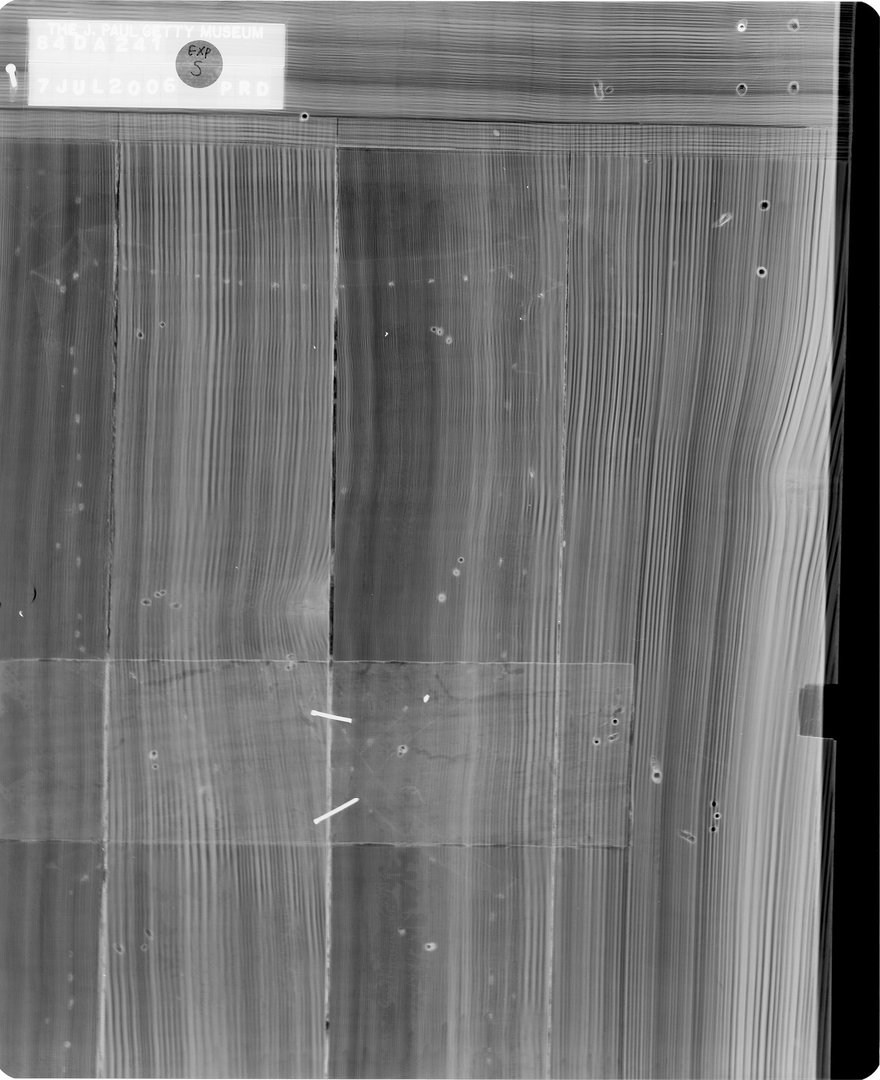 black and white x-ray of the lower left door of one of the cabinets, revealing the hidden joinery that connects the multiple vertical wooden panels that make up the cabinet door