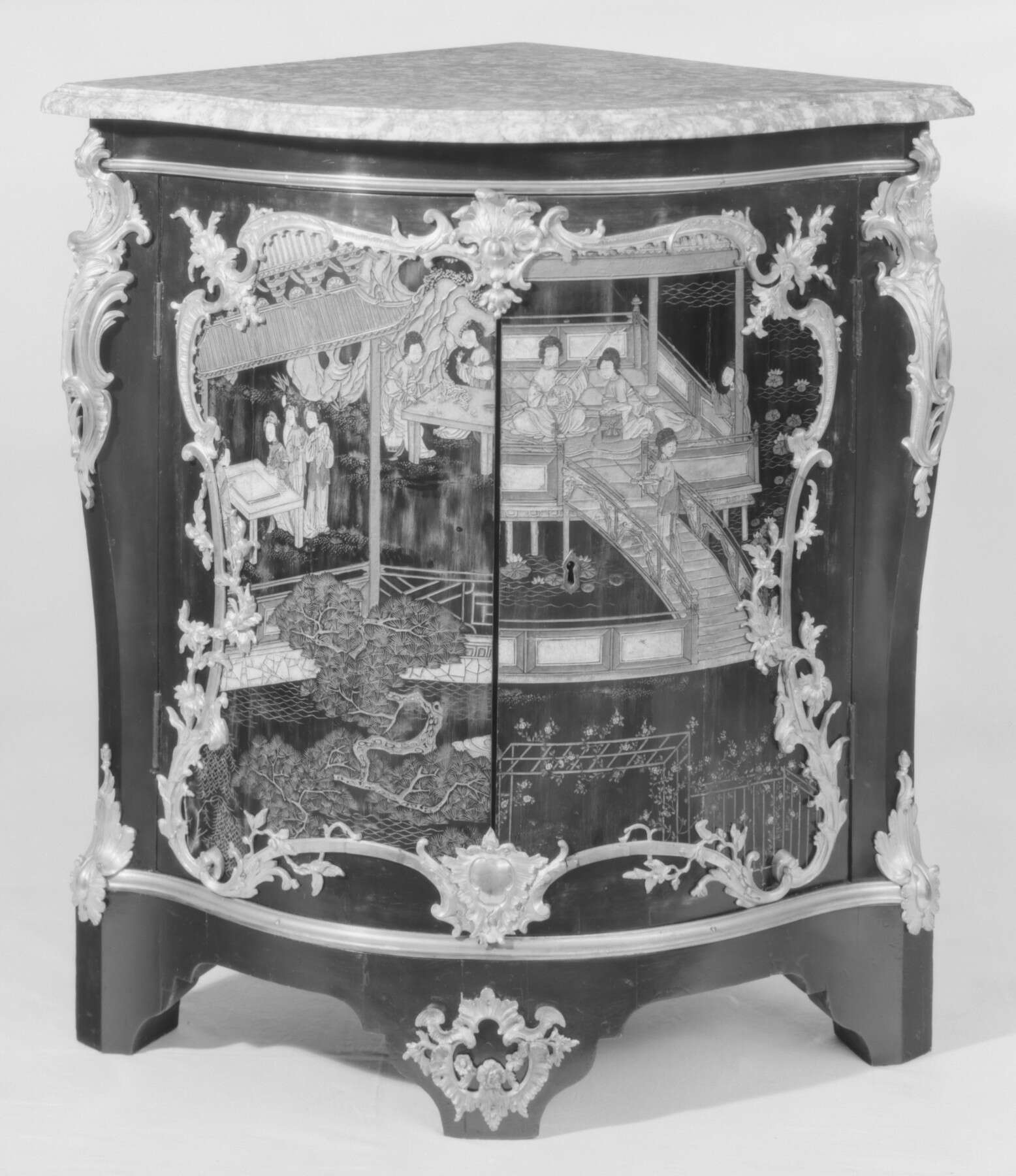 black and white image of another corner cabinet decorated with elaborate Asian imagery showing a domestic interior with women and gardens