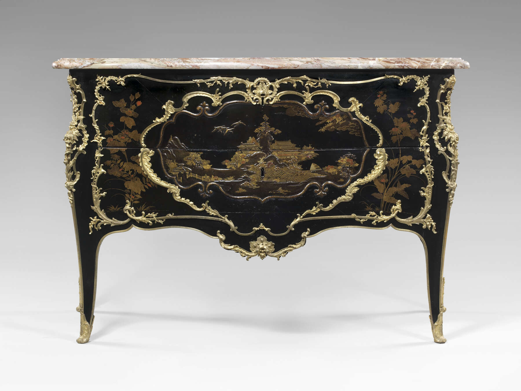 frontal view of another commode, decorated similarly to the Getty commode, with gilt bronze mounts, black, gold, and red lacquer designs, and a red and white veined marble top