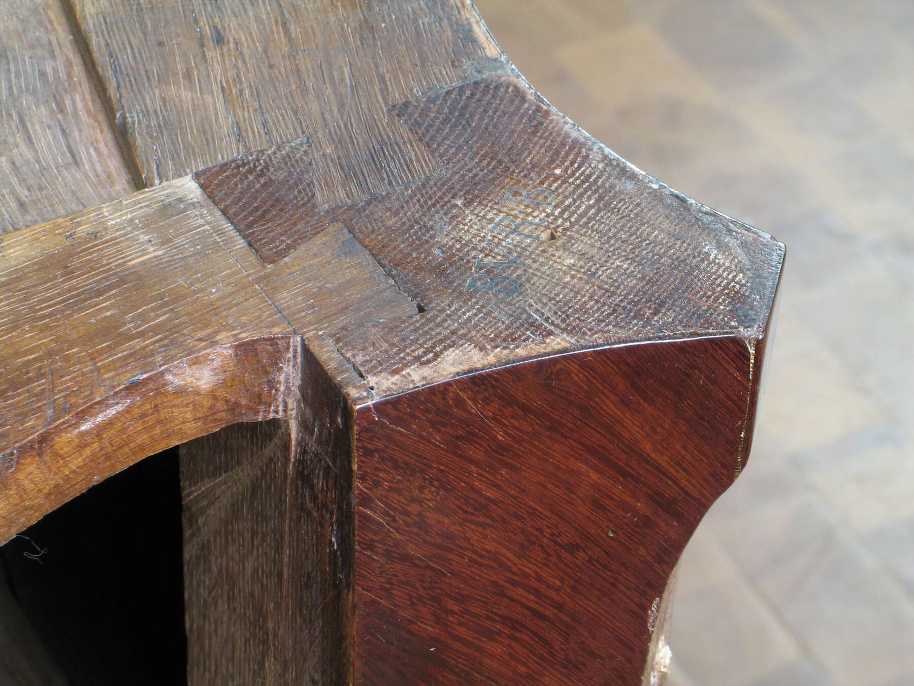 detail of the top of one of the leg joints, showing multicolored wooden pieces fitted tightly together