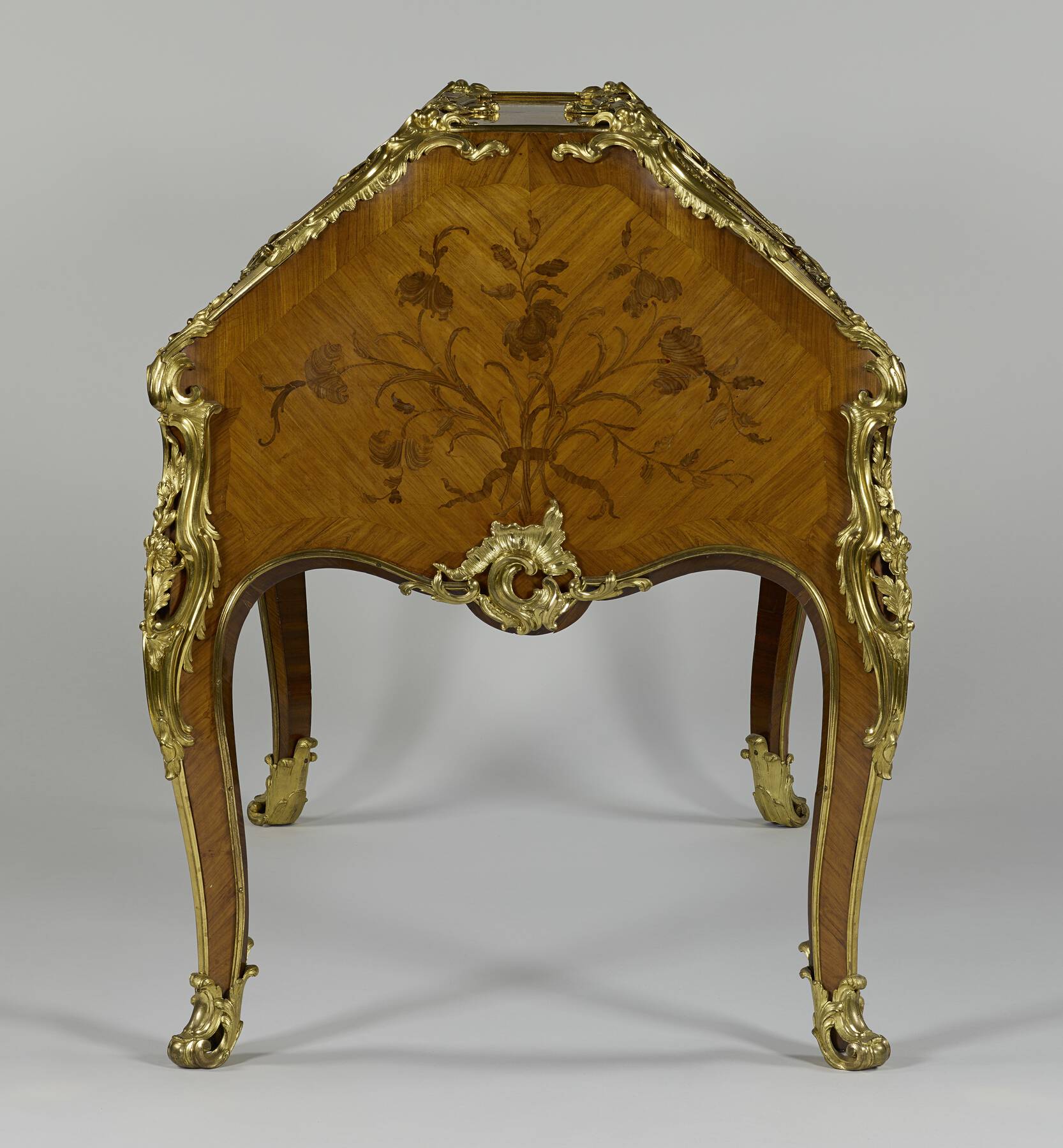 side view of the desk, showing the floral marquetry and gilt bronze mounts