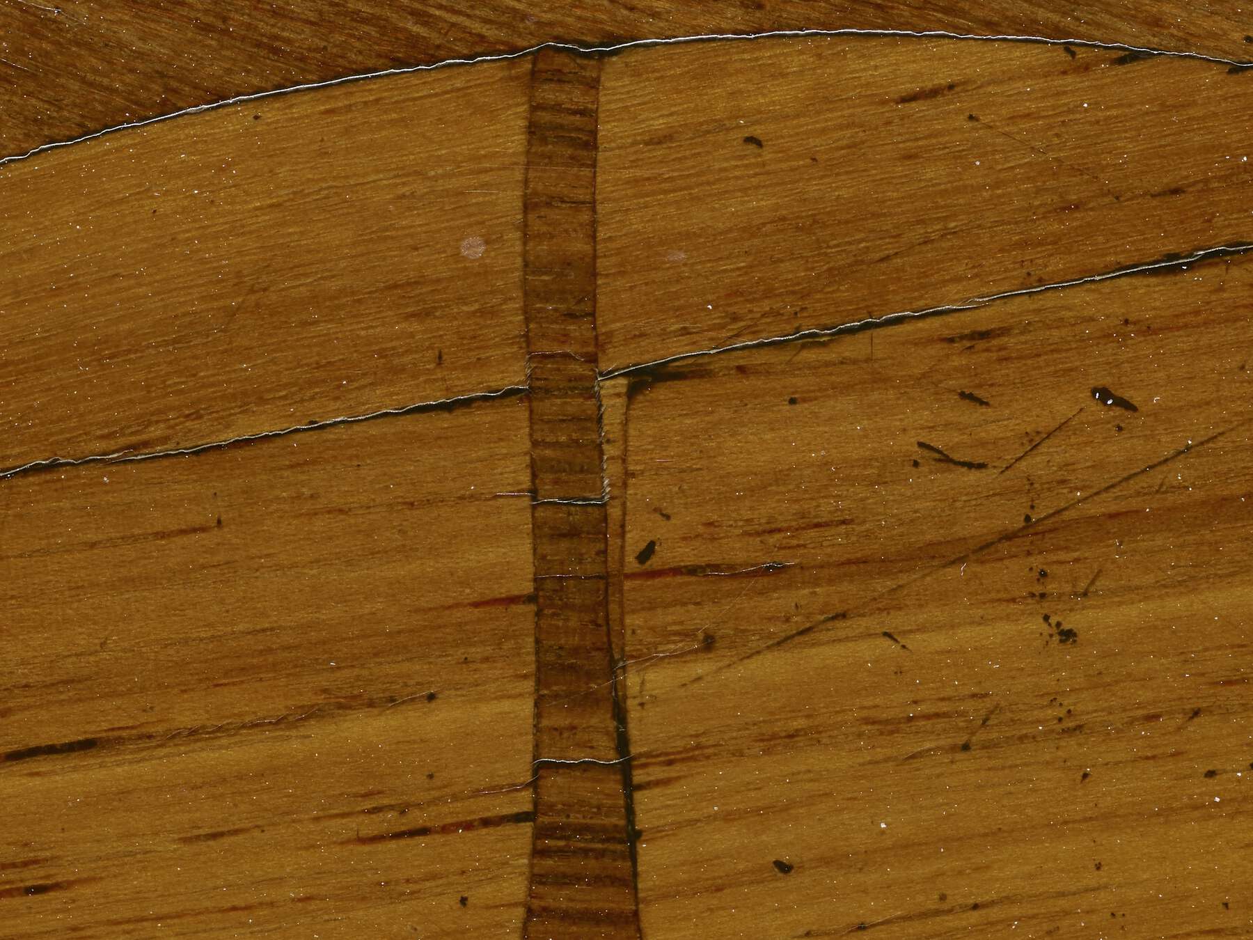 close-up of the marquetry against the veneer with visible knife marks