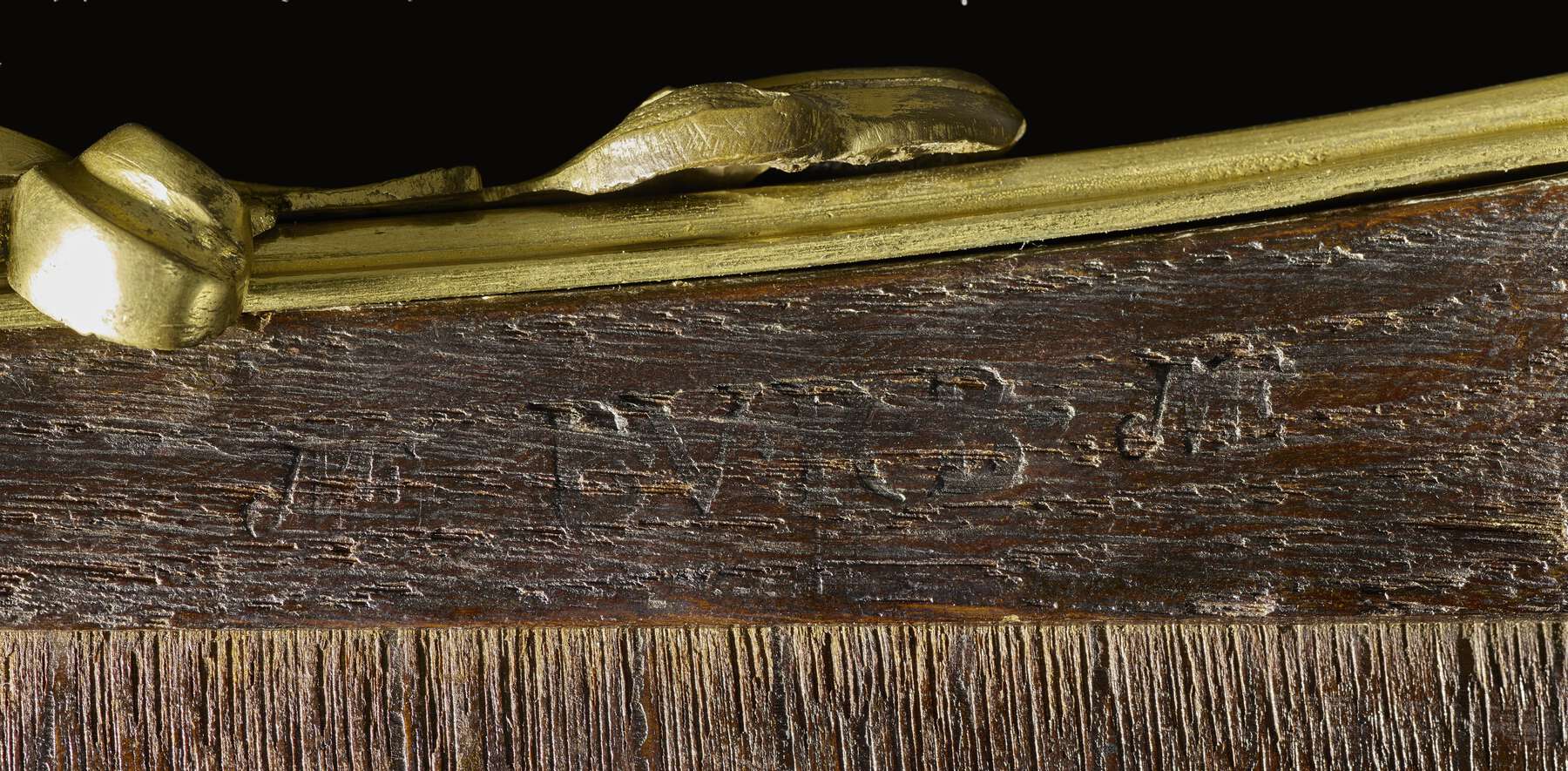 detail of the underside of the table, showing the legible remnants of imprinted stamps