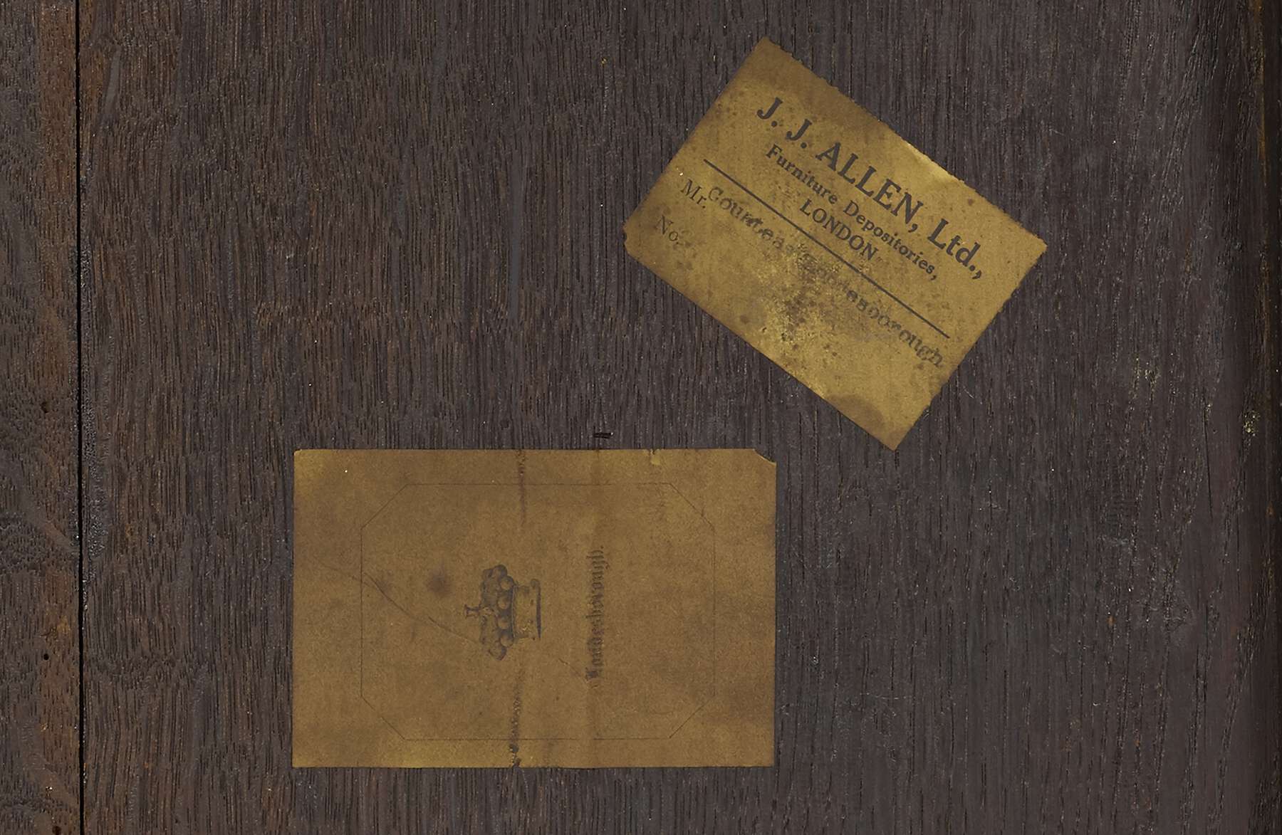 detail of the underside of the table, showing two rectangular paper labels